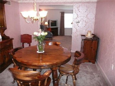 The formal dining room offers French doors to the 