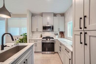 Kitchen with backsplash, a sink, appliances with 
