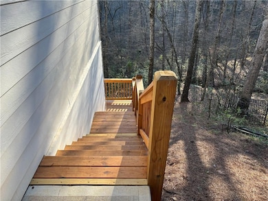 Side entry for the basement and the back wooded ya