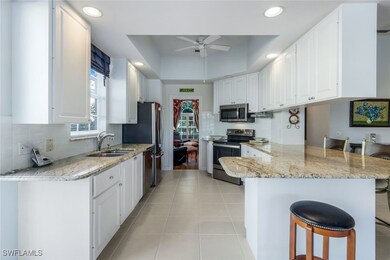 Kitchen featuring kitchen peninsula, a breakfast b