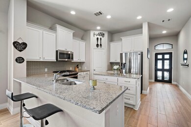 Beautiful gourmet kitchen featuring a breakfast ba
