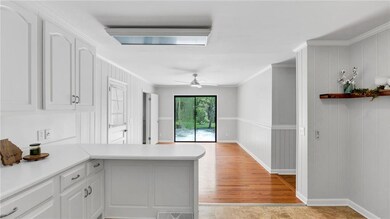 Kitchen featuring a ceiling fan, ornamental moldin