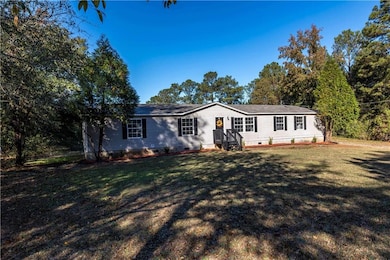 View of front facade with crawl space and a front lawn