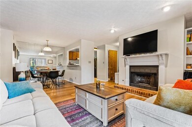Living area featuring a brick fireplace, wood fini