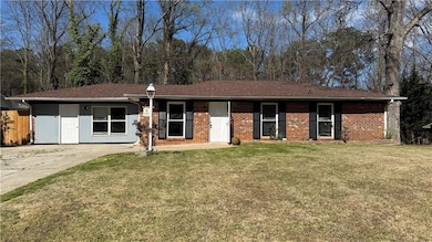 Ranch-style house with a front lawn and fence