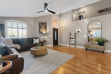Living area with a ceiling fan, wood finished floors, high vaulted ceiling, and recessed lighting