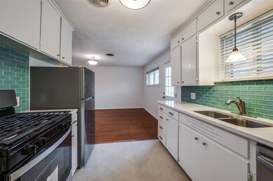 Kitchen featuring tasteful backsplash, range with 