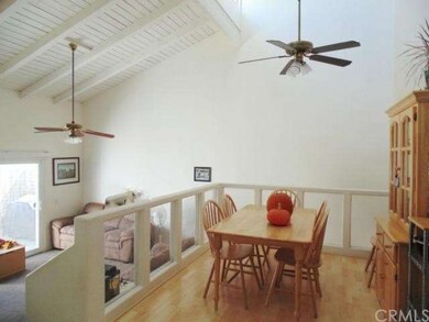 Eating area and living room with vaulted wood-beam
