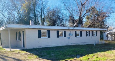 View of side of home featuring a lawn