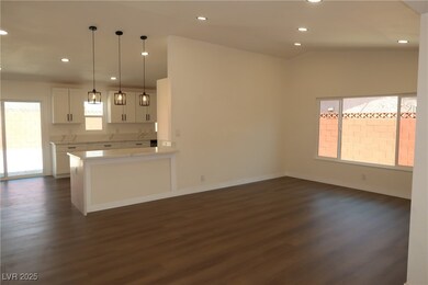 Kitchen with dark wood-type flooring, white cabine