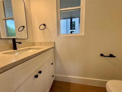 Bathroom featuring toilet, wood finished floors, 