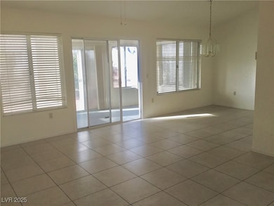 Empty room featuring a notable chandelier and ligh