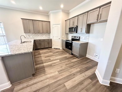 Kitchen featuring granite counters and stainless steel appliances