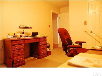 Another view of the additional bedroom that is being used as an office. The Bay window has a seat with storage area.;