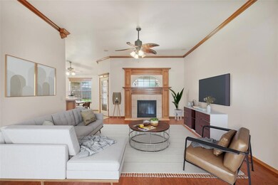 Living room with ceiling fan, a fireplace, light h