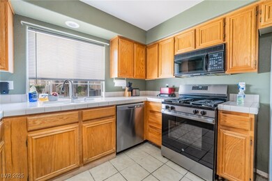Kitchen with tile countertops, light tile patterne