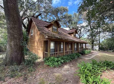 View of side of property featuring a porch