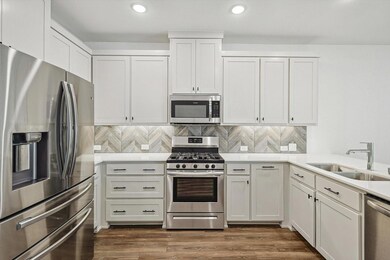 Kitchen with dark hardwood / wood-style floors, si