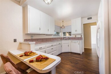 Spacious kitchen with plenty of counter space, cabinets, and a corner sink to view the streetscape!