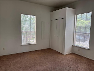 Unfurnished bedroom with carpet floors, multiple 