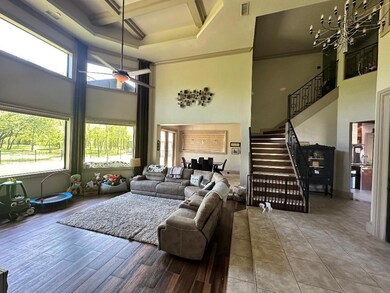 Living area featuring a towering ceiling, coffered