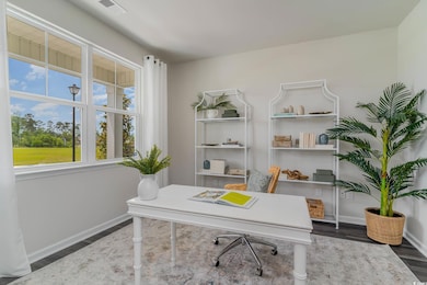 Office with wood finished floors and baseboards