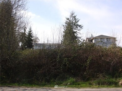 Standing on the cul-de-sac looking up at the lot.  The homes behind have sweeping views.