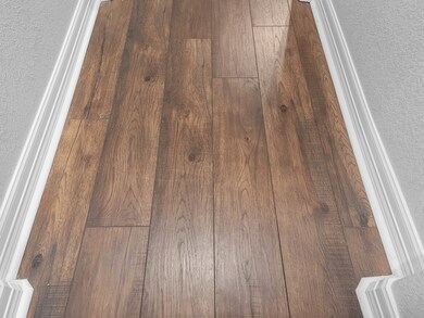 CLOSE UP OF THE GORGEOUS LUXURY LAMINATE FLOORING!