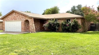 Ranch-style house featuring brick siding, a garage, and concrete driveway