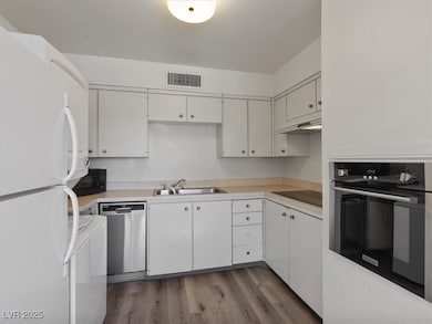 Kitchen with black appliances, under cabinet range