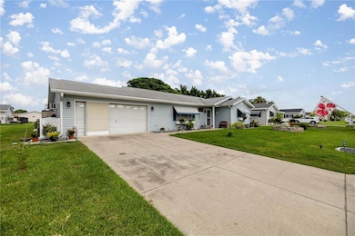 FRONT OF HOME SHOWS GARAGE / DRIVEWAY