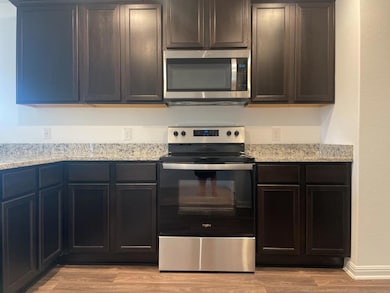 Kitchen featuring appliances with stainless steel