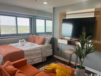 Bedroom featuring wood finished floors, baseboards