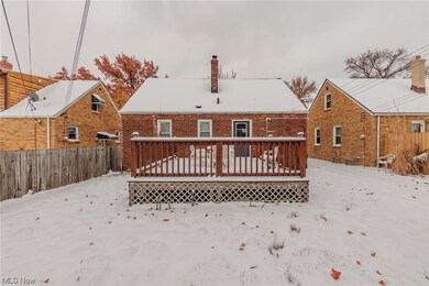 Snow covered house with a deck