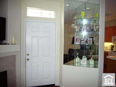 Media niche and glass shelves in built-in cabinet.