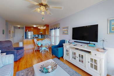 Living area with ceiling fan with notable chandeli