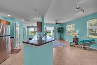 Kitchen featuring stainless steel fridge, sink, tr