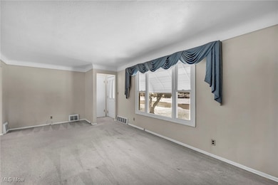 Spare room with carpet and a textured ceiling