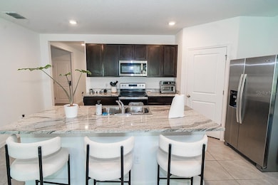 Kitchen with quartz countertops and stainless appliances