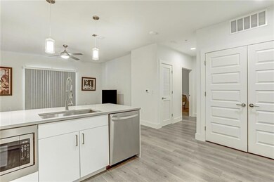 Kitchen with stainless steel appliances, hanging 