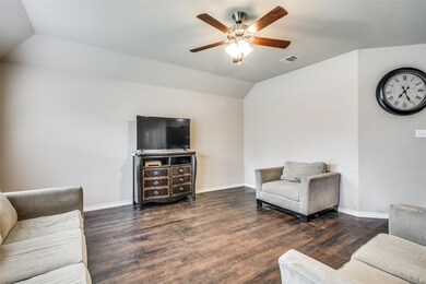 Living room with dark hardwood / wood-style floors, ceiling fan, and vaulted ceiling