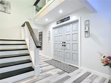 Foyer featuring plank tile flooring and custom sta