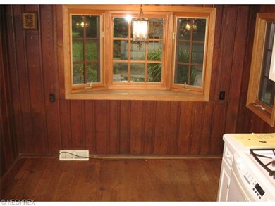 Eating area in kitchen has a bay window.