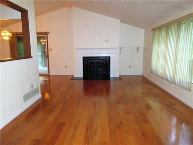 This living room boasts gleaming new hardwood floo