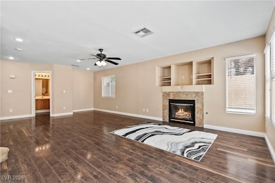 Unfurnished living room featuring baseboards, wood