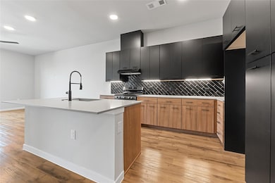 Kitchen featuring stainless steel range with gas 