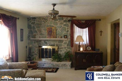 nice sized living room with big bay window and wood burning fireplace