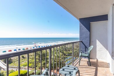 Balcony featuring a view of the beach and a water 
