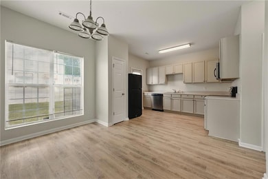 Kitchen featuring a notable chandelier, appliances
