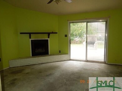 Family Room with fireplace and sliding door to bac
